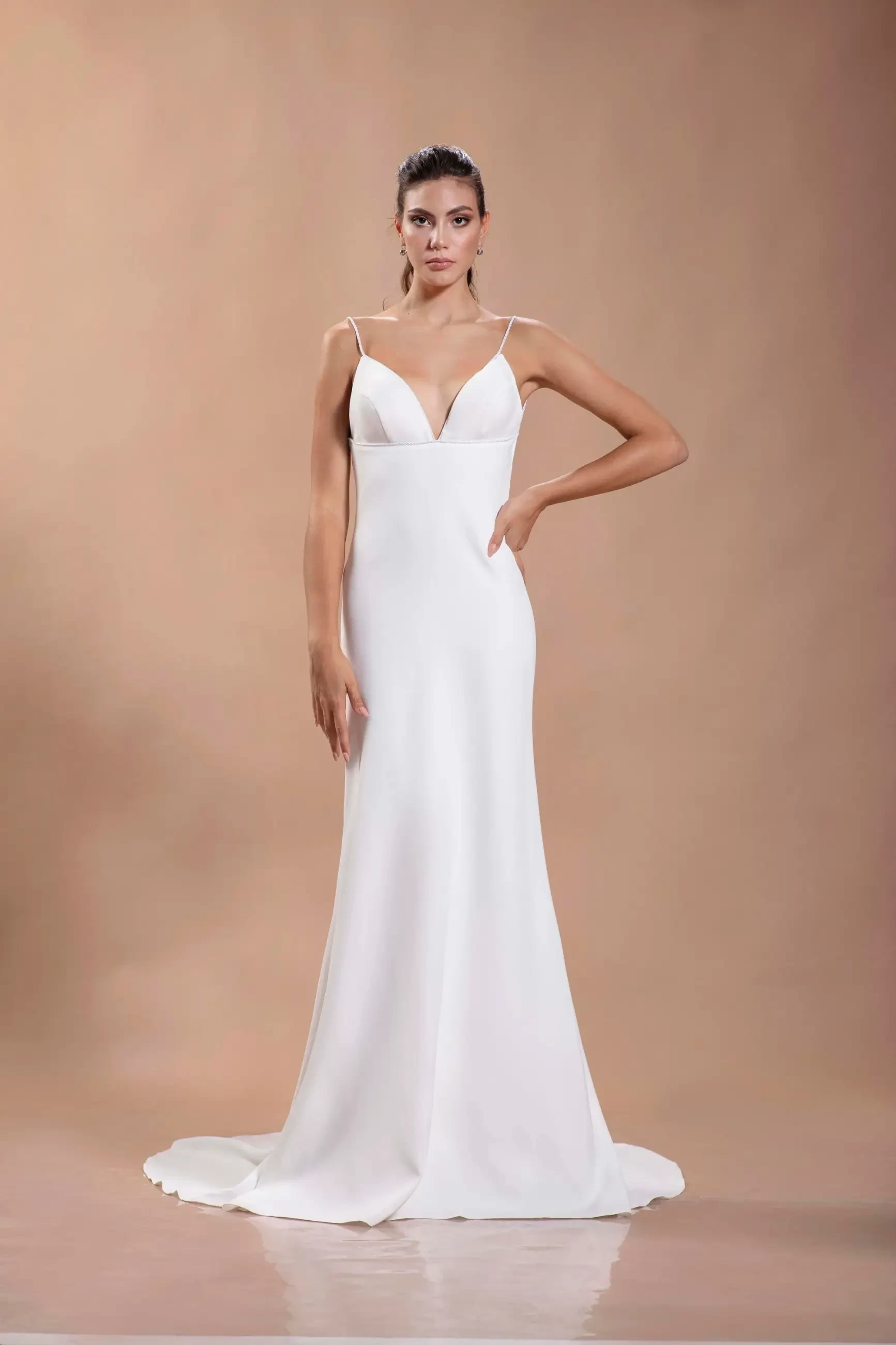 model is wearing a crepe sleeveless spaghetti strap wedding dress