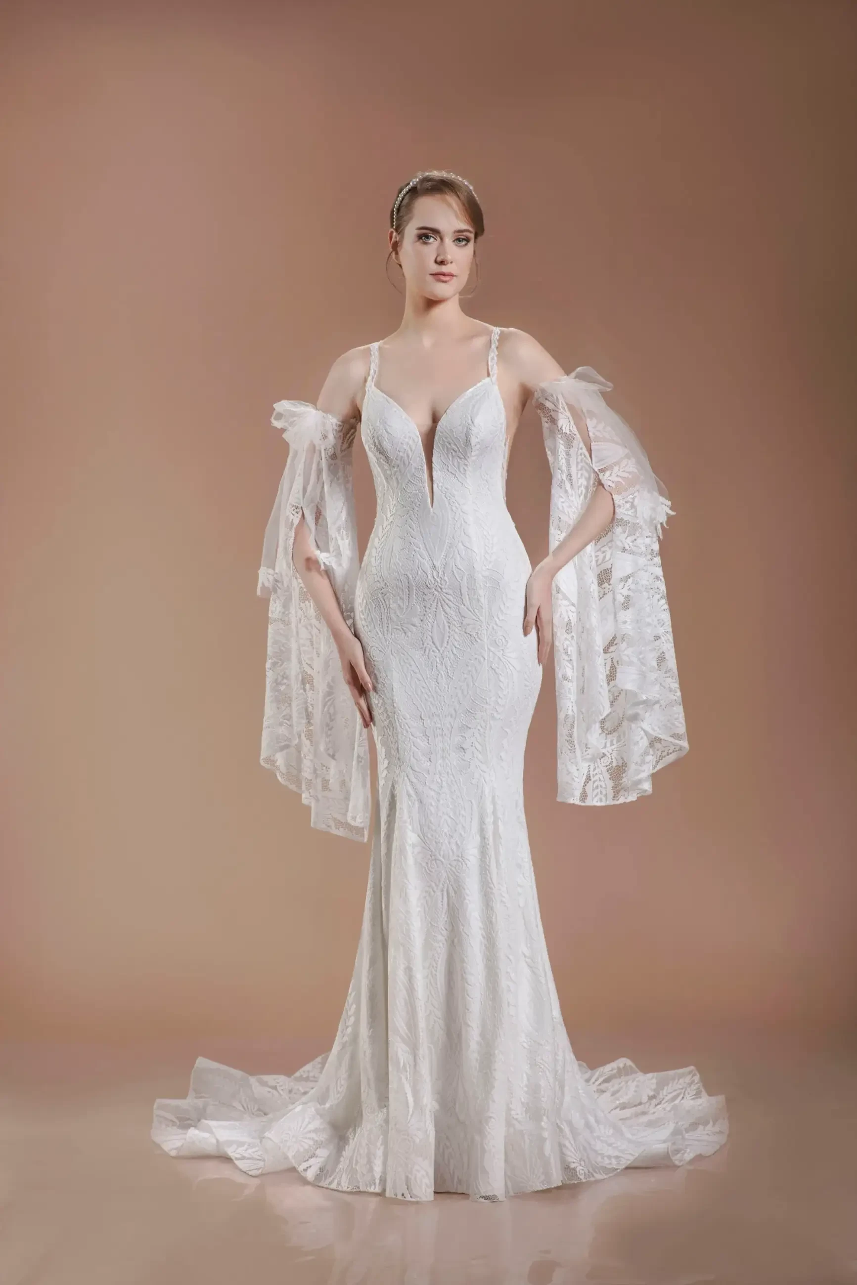 model is wearing a fit and flare bridal gown with elaborate boho chic blouson sleeves