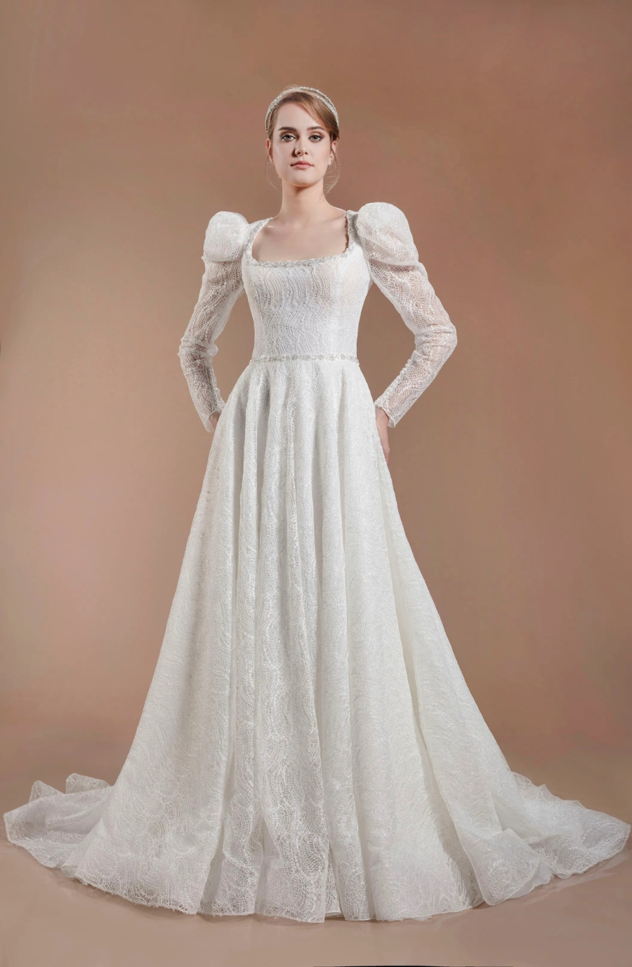 model is wearing a square neckline ball gown wedding dress