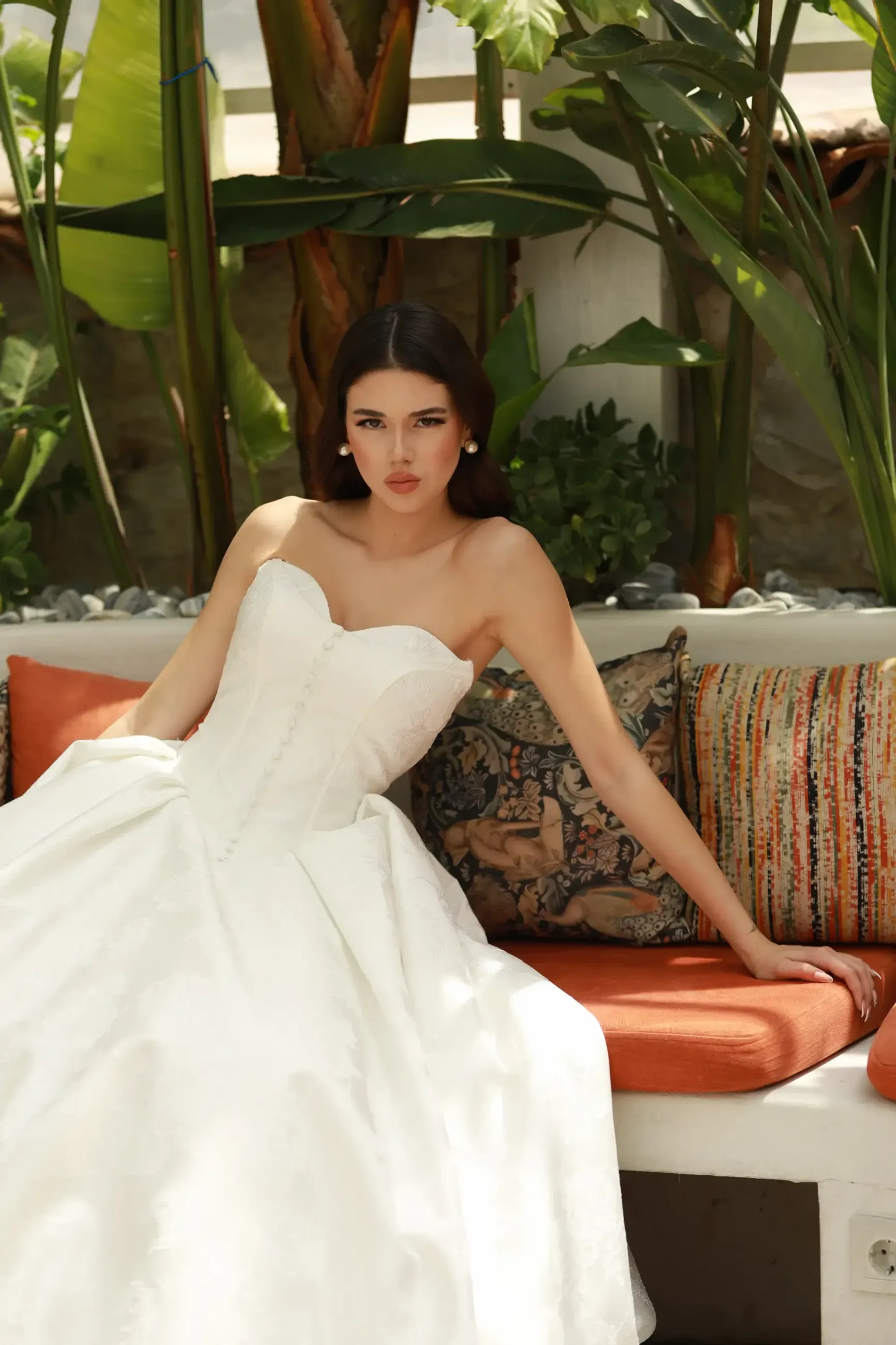 model is wearing a strapless jacquard wedding dress