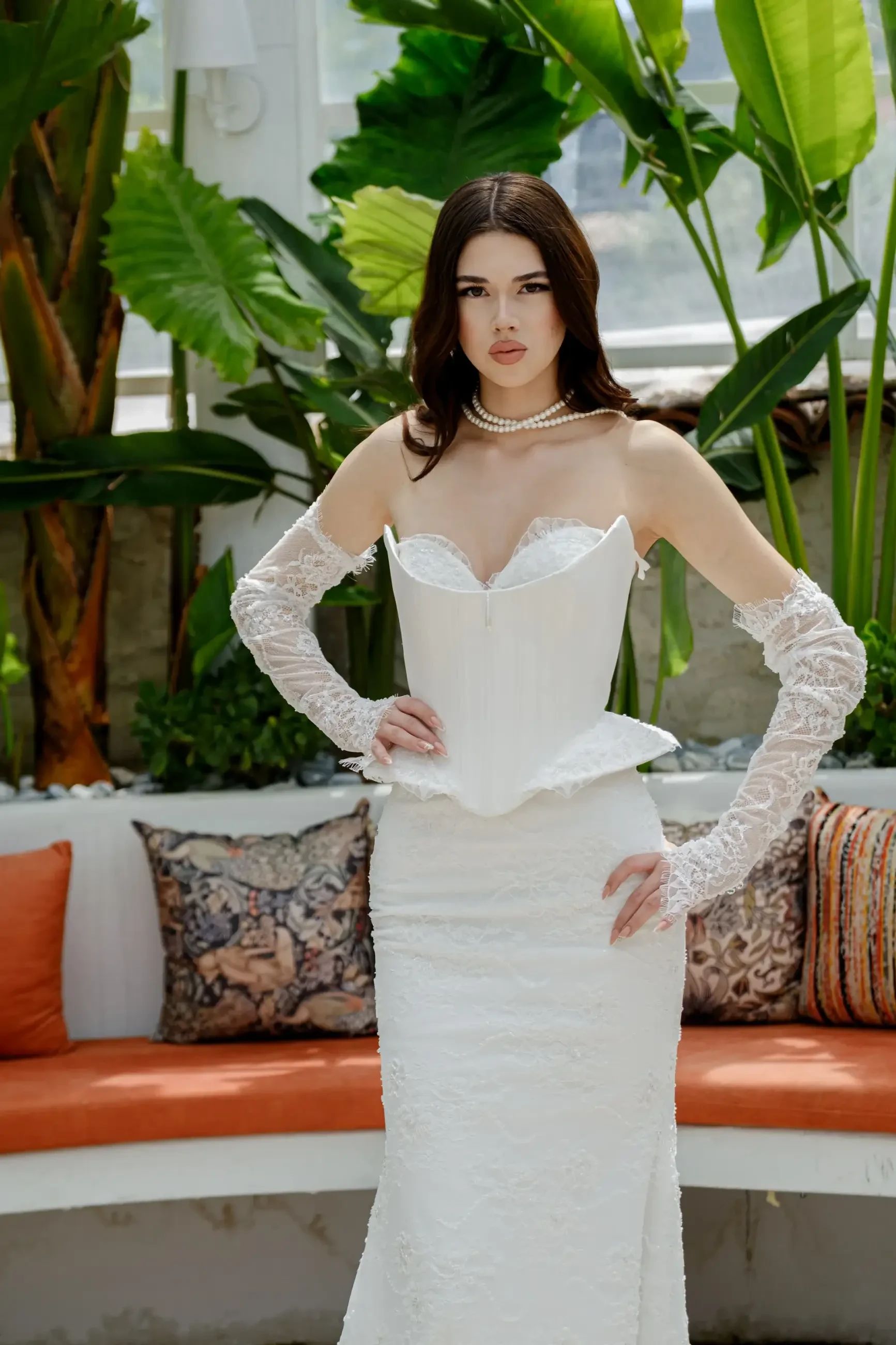 model is wearing a corset wedding dress with lace trimmed veil